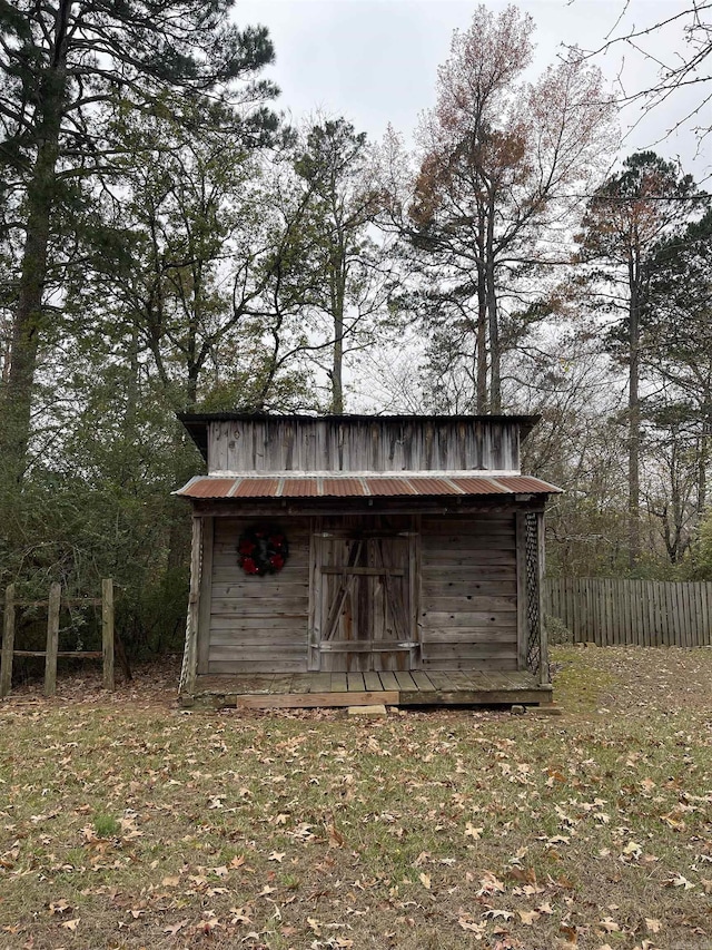 view of shed featuring fence