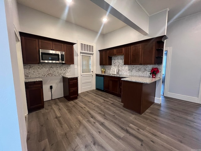 kitchen featuring dishwashing machine, a peninsula, a sink, stainless steel microwave, and dark wood finished floors