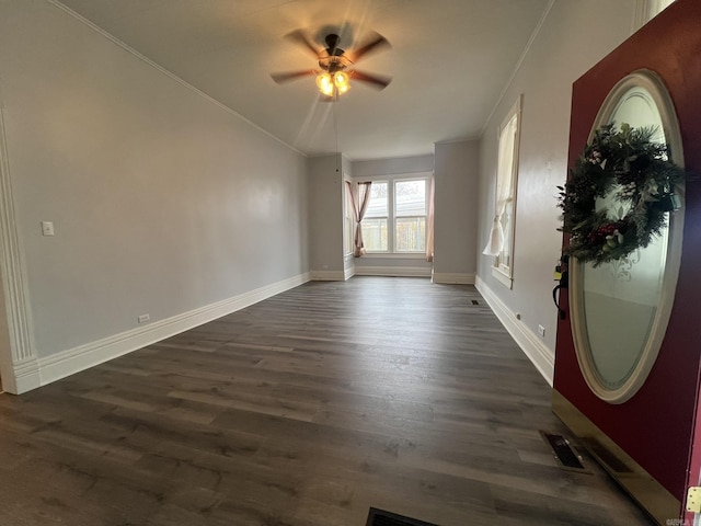1905 Bethesda, Mena, AR 71953 - entrance foyer featuring a ceiling fan, dark wood-type flooring, baseboards, and ornamental molding
