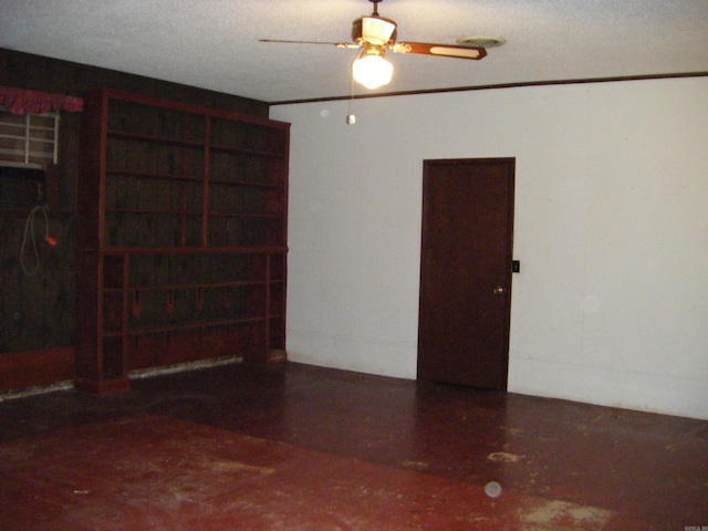 spare room featuring a textured ceiling and ceiling fan