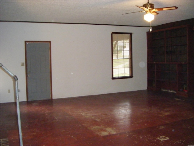 unfurnished room featuring ceiling fan and a textured ceiling