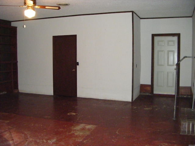 spare room with a textured ceiling and ceiling fan