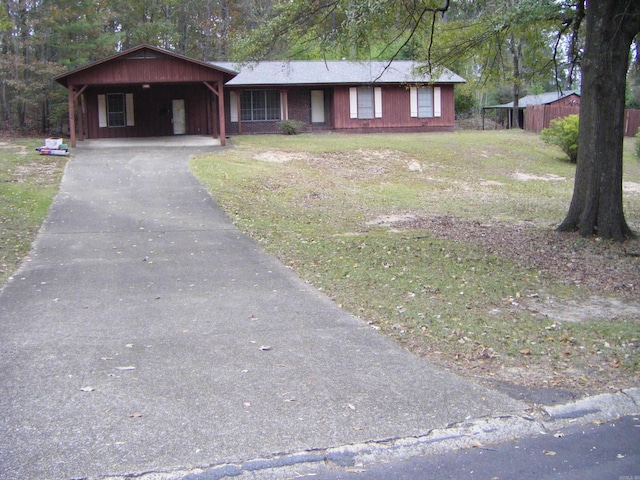 ranch-style house featuring a carport and a front lawn