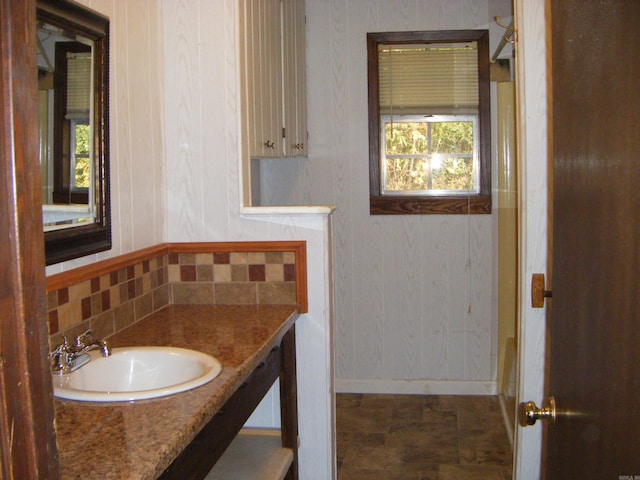 bathroom with decorative backsplash and vanity