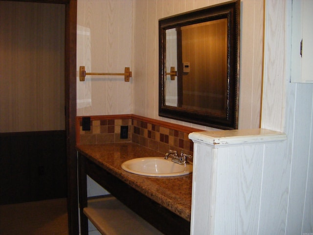 bathroom featuring vanity and tasteful backsplash