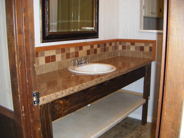 bathroom with decorative backsplash and vanity