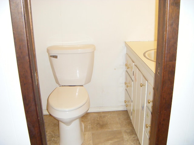 bathroom featuring tile patterned flooring, vanity, and toilet