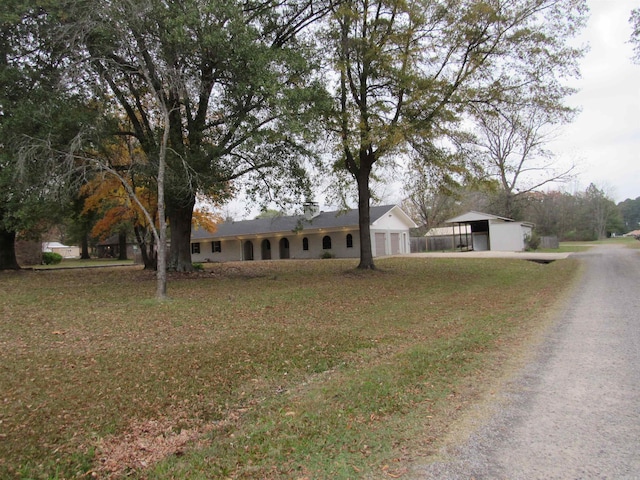 ranch-style house featuring a front yard and a garage