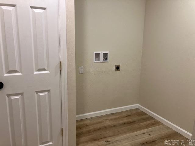 clothes washing area featuring hardwood / wood-style flooring, hookup for an electric dryer, and washer hookup