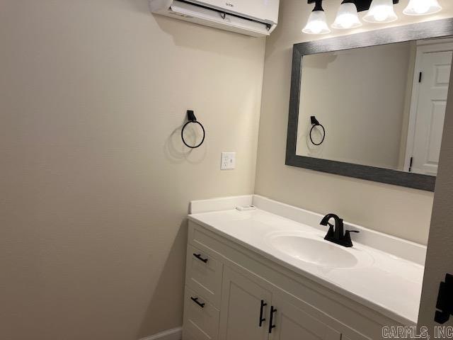 bathroom with an AC wall unit and vanity