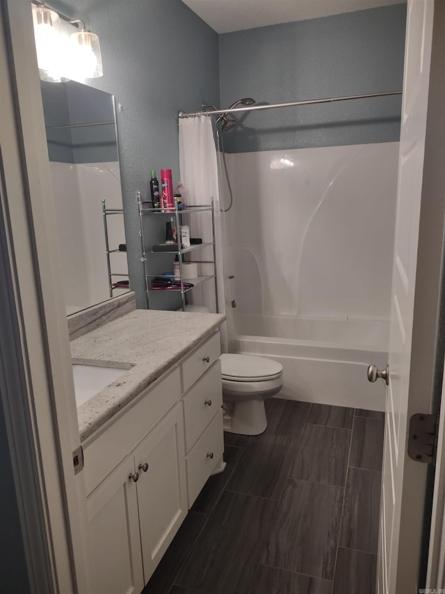 full bathroom with shower / bath combination with curtain, vanity, and toilet