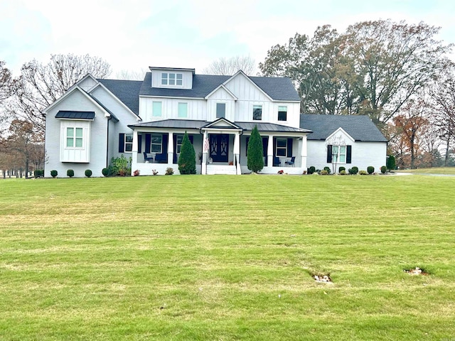 view of front facade with a front yard and covered porch