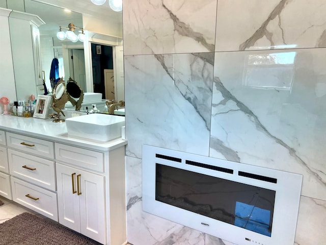 bathroom featuring vanity and tile walls