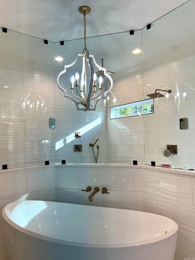 bathroom with a bathtub, tile walls, and a notable chandelier