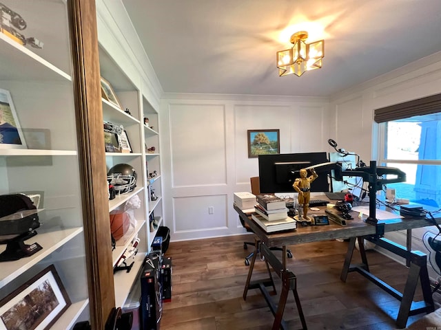 office with dark hardwood / wood-style flooring and an inviting chandelier