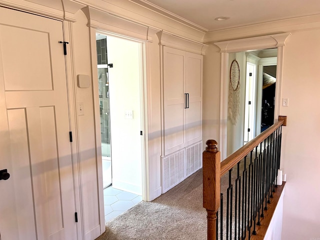 hall featuring carpet flooring and crown molding