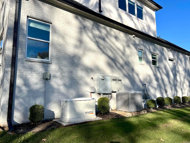 view of property exterior with a yard and central AC