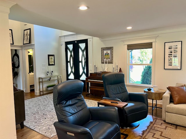 living room with hardwood / wood-style floors and ornamental molding