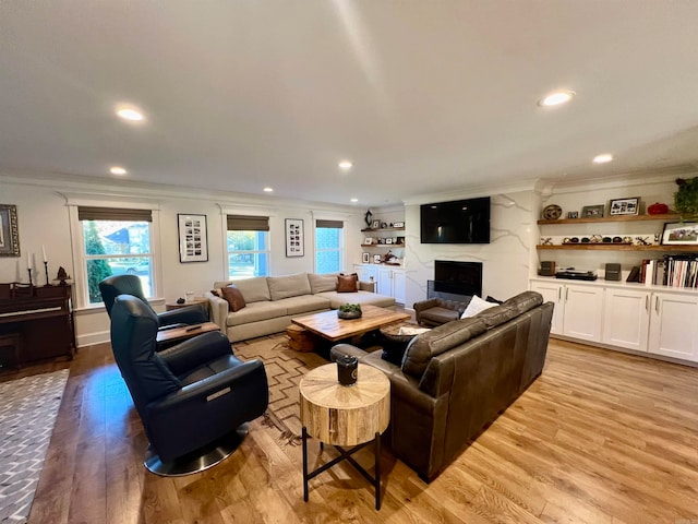 living room with light hardwood / wood-style flooring and ornamental molding