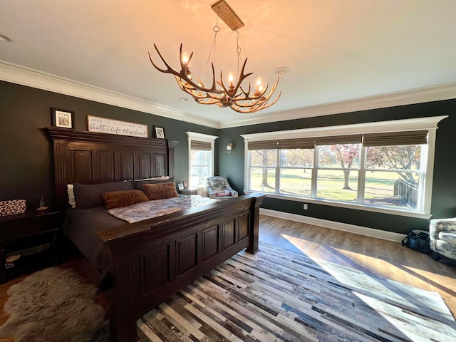 bedroom with crown molding, a chandelier, and light wood-type flooring