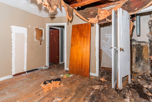 unfurnished bedroom with dark hardwood / wood-style flooring