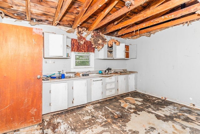 kitchen with white cabinets and beamed ceiling