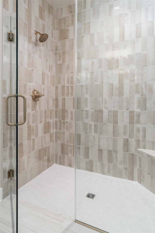 bathroom with a shower with shower door