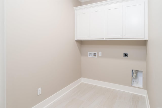 laundry room featuring hookup for an electric dryer, hookup for a washing machine, and cabinets