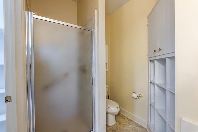 bathroom featuring an enclosed shower and toilet