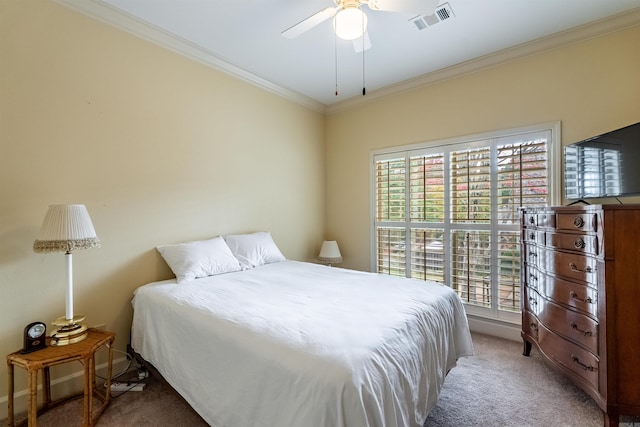 carpeted bedroom featuring ceiling fan and ornamental molding