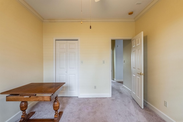 interior space with light carpet, a closet, and ornamental molding