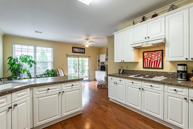 kitchen featuring white cabinets, dark hardwood / wood-style flooring, ceiling fan, and white stovetop