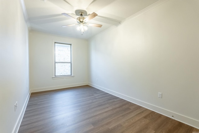 empty room with ceiling fan, dark hardwood / wood-style flooring, and ornamental molding