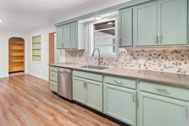 kitchen featuring sink, green cabinets, light hardwood / wood-style flooring, stainless steel dishwasher, and crown molding