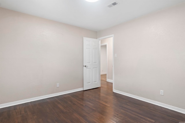 empty room featuring dark hardwood / wood-style flooring