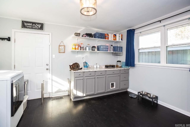 interior space with independent washer and dryer and dark hardwood / wood-style floors