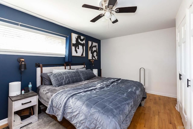 bedroom featuring hardwood / wood-style floors and ceiling fan