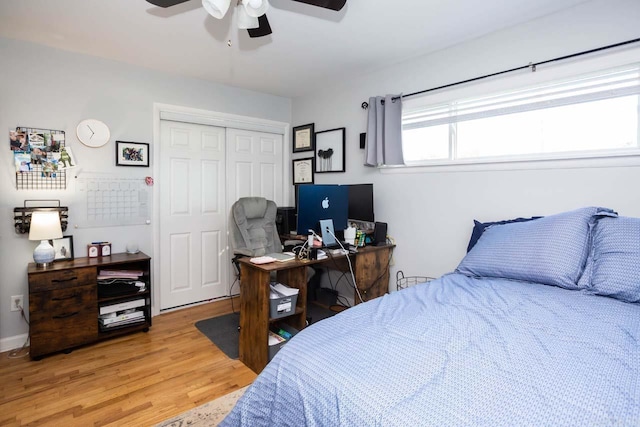 bedroom featuring ceiling fan, wood-type flooring, and a closet