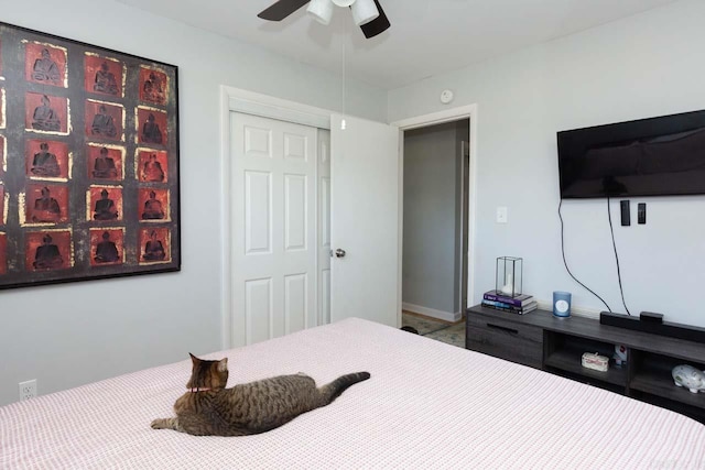 bedroom with ceiling fan and a closet