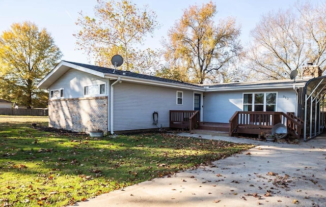 rear view of house featuring a yard