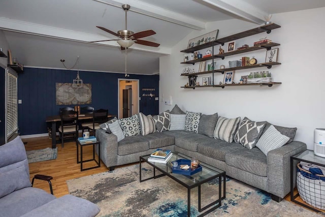 living room with hardwood / wood-style flooring, vaulted ceiling with beams, and ceiling fan