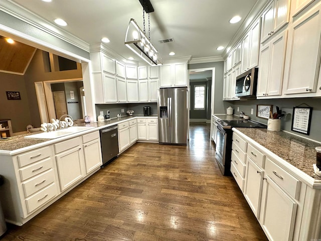 kitchen with pendant lighting, white cabinetry, kitchen peninsula, and appliances with stainless steel finishes