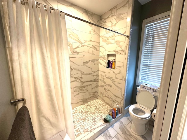 bathroom featuring curtained shower and toilet