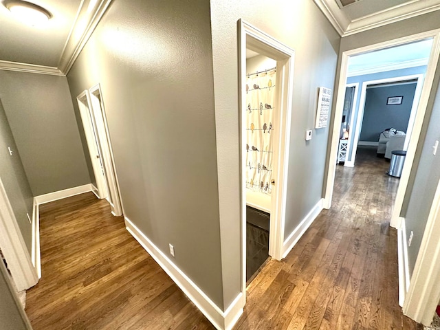 hall with wood-type flooring and crown molding