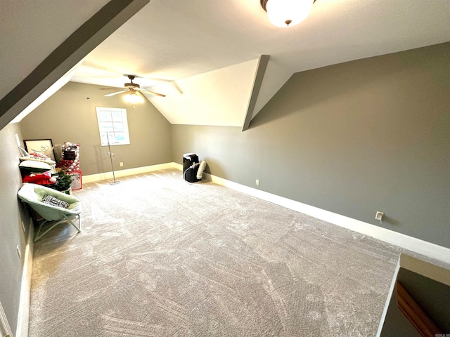 additional living space featuring carpet flooring, ceiling fan, and vaulted ceiling