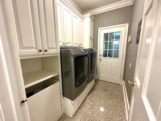 laundry room featuring cabinets, washing machine and dryer, and crown molding