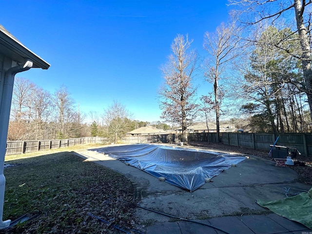 view of pool featuring a lawn