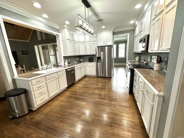 kitchen with white cabinetry, sink, hanging light fixtures, kitchen peninsula, and appliances with stainless steel finishes