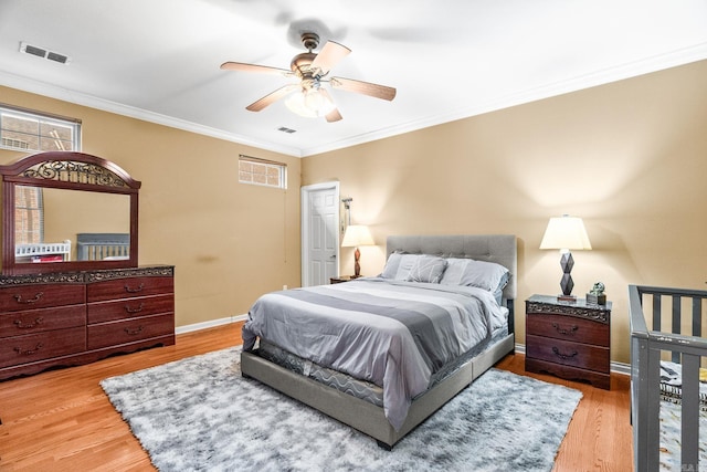 bedroom with ceiling fan, light wood-type flooring, and crown molding