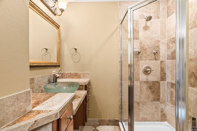 bathroom with vanity and a shower with shower door